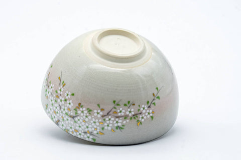 The cup tipped to show its foot and underside.