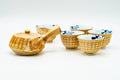 Yellow brush-glazed Arita-yaki tea set grouped together, showing the ribbed side-handle teapot beside two yunomi cups with blue floral interiors