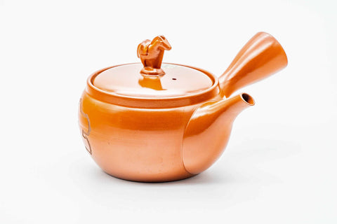 Red shudei Tokoname kyusu, raised three-quarter view showing the horse-shaped lid knob and handle