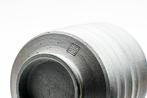 Close-up of an inverted cup's ribbed lower body and foot.