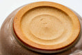 Underside of the pink-beige Hagi-yaki kyusu showing the unglazed clay foot ring