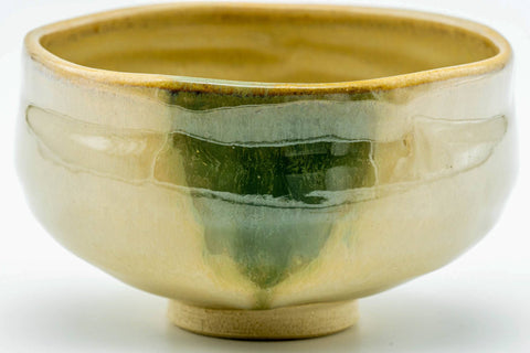 Side view of the Akahada chawan showing the green drip and cream glaze