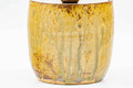 Front view emphasising the vertical brown drip glaze on the body of the jar.