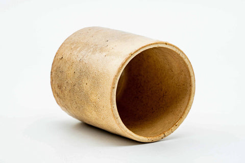 Teacup tilted to show the lower body and unglazed foot.