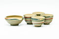 Marbled nerikomi Tokoname-yaki tea set: katakuchi spouted water cooler with colorful red, green, and cream marbled bands, shown with four matching teacups.