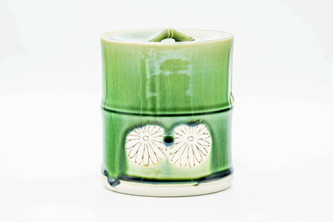 Front view of the bamboo-shaped jar emphasising the segmented form and green drip glaze.