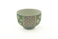 The Arita yunomi rotated slightly, showing the patterned band of green florals and blue geometric design