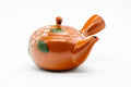 Japanese Kyusu - Floral Red Shudei Tokoname-yaki Mesh Basket Teapot - 280ml - raised three-quarter front view showing the lid knob, side handle and floral motif
