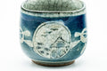 Overhead view into the cup, blue body with a painted medallion.
