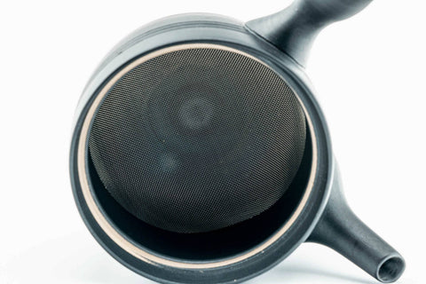 The kyusu with the lid removed, showing the built-in mesh strainer; the lid rests beside it.