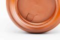 Underside of the teacup, showing the red clay foot.