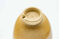Underside of a cup, showing the unglazed clay foot ring.