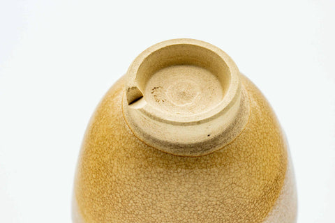 Underside of a cup, showing the unglazed clay foot ring.