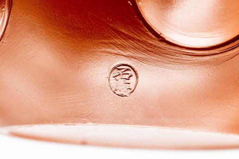Japanese Kyusu - Smooth Red Shudei Tokoname-yaki Ceramic Teapot - 270ml - closeup of the underside showing the impressed circular maker's stamp