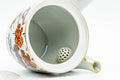 Kyusu with lid removed, looking inside to reveal the built-in ceramic mesh strainer at the spout opening.