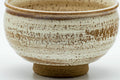 Side view of the chawan showing the milky white glaze over the brown banded body