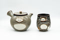 Japanese Tea Set - Tanuki Raccoon Dog Kyusu and Yunomi - front view of the teapot beside the matching teacup