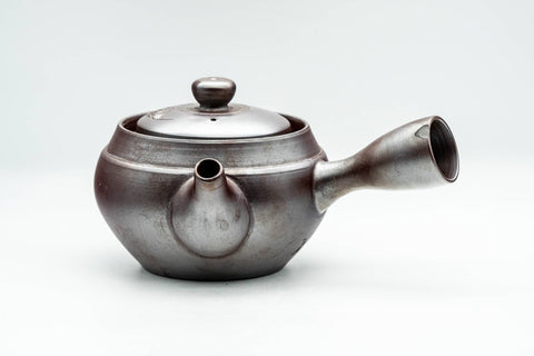 Three-quarter view of the dark Banko teapot showing spout, side handle and engraved body