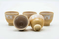 The set with one cup tipped on its side to show the foot.