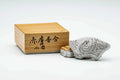 White Akahada-yaki kogo (incense container) displayed beside its signed wooden storage box with brush-written calligraphy on the lid.