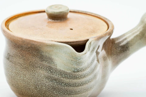 Beige Hagi-yaki kyusu with the lid removed and resting on top, showing the open mouth