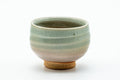 The cup from another angle, showing the indented side.