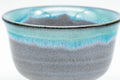 Close-up of a single Agano-yaki yunomi showing the turquoise drip-glaze detail