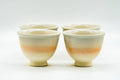 Front view of the four Hagi teacups grouped, showing subtle peach and beige tones