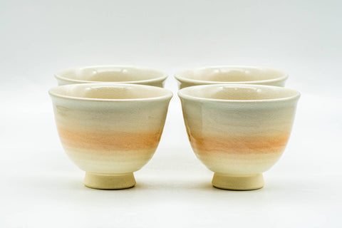 Front view of the four Hagi teacups grouped, showing subtle peach and beige tones