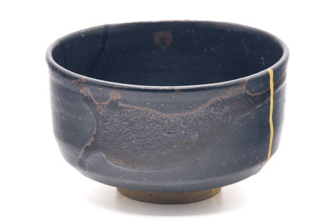 Side view showing the black glaze and the gold kintsugi line.