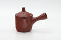 The teapot with the spout to the right and the side handle to the left.