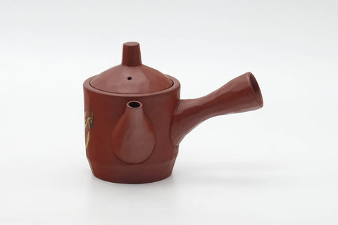 The teapot with the spout to the right and the side handle to the left.