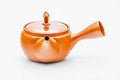 Red shudei Tokoname kyusu, three-quarter view from the rear with the spout to the right
