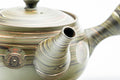 Angled view highlighting the carved circular medallions and the spiral end of the side handle.
