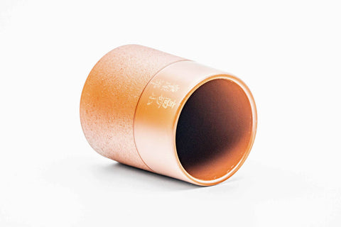 Teacup tilted to show the rim and interior.