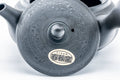 Close-up of the base showing the maker's stamp