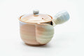 Pink-beige drip-glazed Hagi-yaki kyusu, raised three-quarter view showing the lid knob and handle