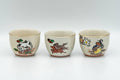Tezumi — Japanese Teacups - Set of 10 Uniquely Decorated Kutani-yaki Guinomi - 40ml — three-quarter view