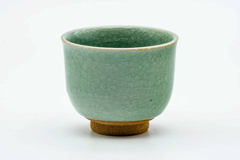 Side view of the celadon teacup, showing the crackled turquoise glaze.