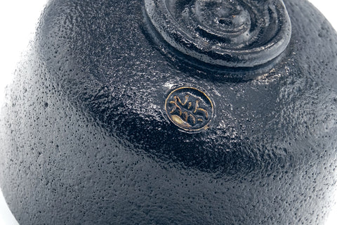 Close-up of the base and foot with the maker's stamp.