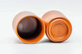 One cup tipped on its side to show the interior and foot, beside the upright second cup.