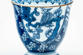 Close-up of the blue-and-white floral and landscape pattern.
