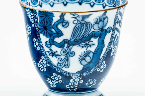 Close-up of the blue-and-white floral and landscape pattern.