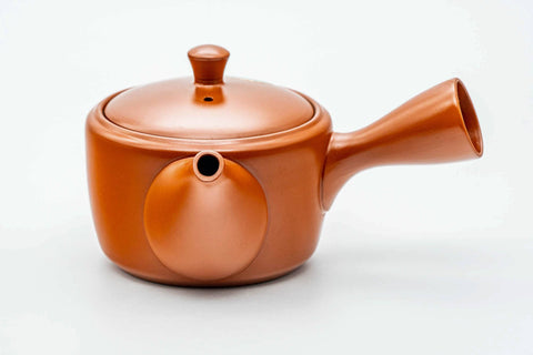 Red shudei Tokoname kyusu, raised three-quarter view showing the lid knob and handle