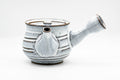 Front view of the white teapot with the spout facing forward and a small knobbed lid.