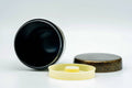 The canister open showing its dark interior, with the cream inner lid and speckled outer lid lying flat beside it.