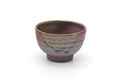 Japanese yunomi teacup, front view, purple-brown body with a green ash-glaze drip down the side.