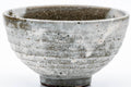 Front view of the chawan highlighting the milky drip glaze and texture.