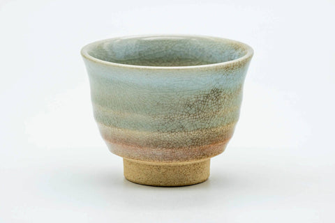 Side view of the teacup, showing the mottled weathered glaze.