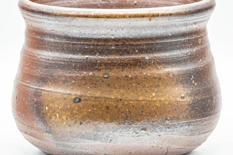 Side view of the Bizen-yaki kensui showing its ribbed earthy clay body